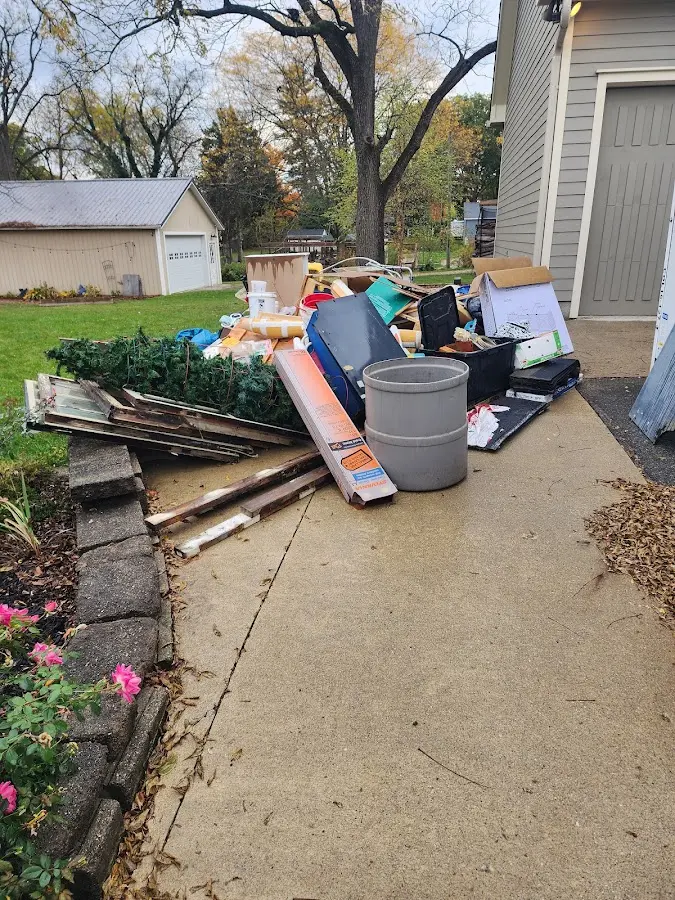 Dumpster being loaded with debris for Roofing Dumpster Rental in Brunswick